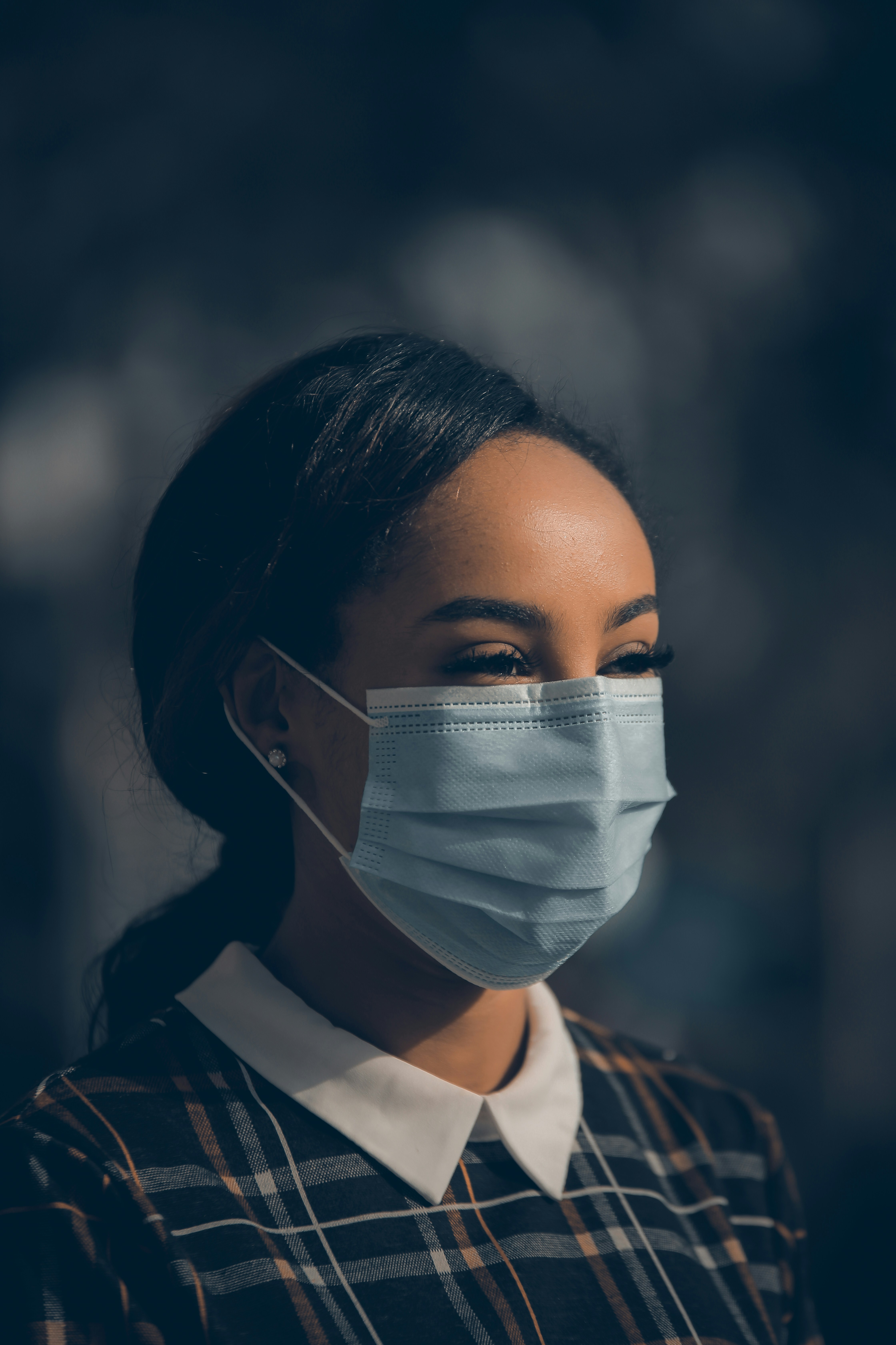 woman in black and white shirt with white face mask