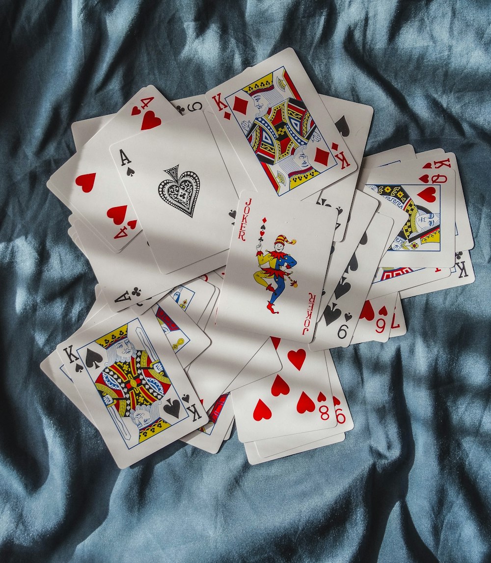playing cards on blue textile