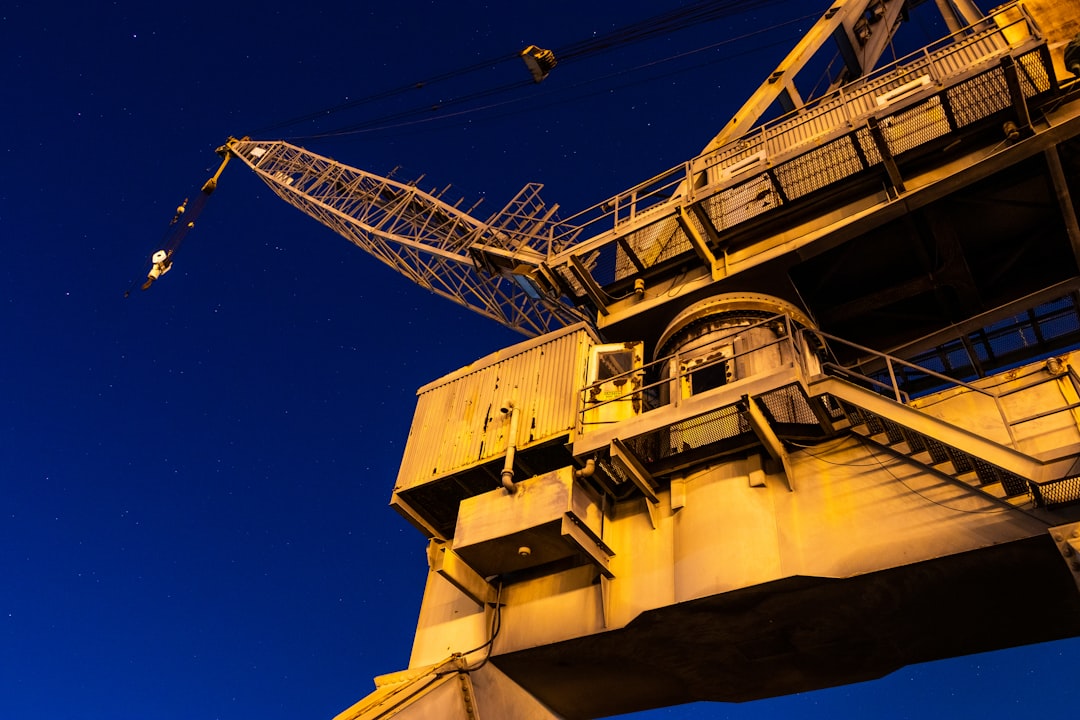 yellow and gray crane under blue sky during night time