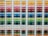 A neatly organized assortment of colorful paper sheets is displayed on shelves. Each row contains papers of a different color, forming a gradient from light to dark shades. The shelves are structured in columns, creating a visually appealing and orderly arrangement.