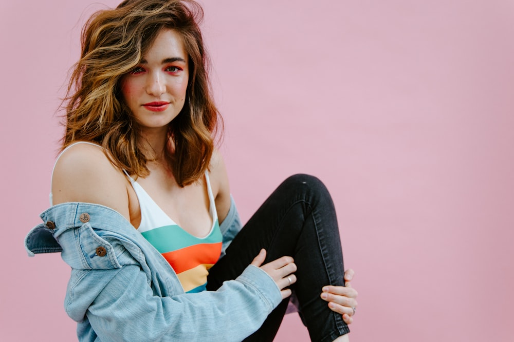 woman in orange tank top and blue denim jacket