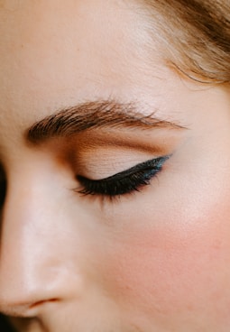 woman with red lipstick and black mascara