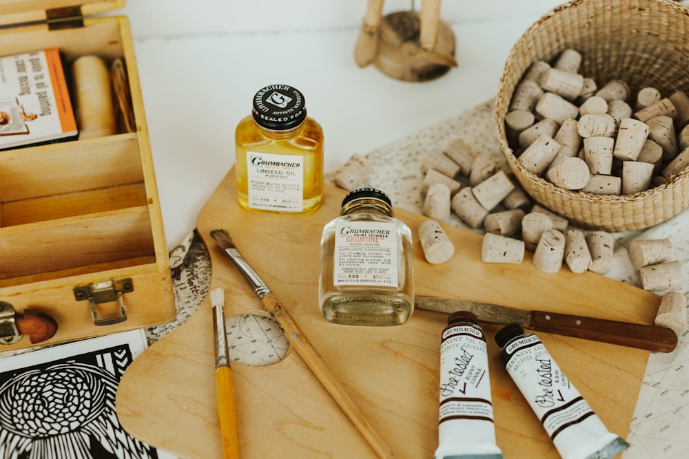 assorted condiment bottles on white wooden table