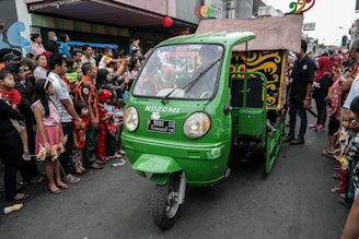 A diverse group of Big Giant Rides drivers and merchants smiling together in a vibrant city street setting.