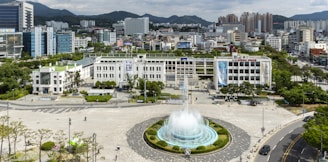 people walking on park near fountain during daytime