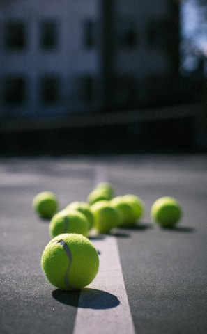 green tennis ball on gray concrete floor