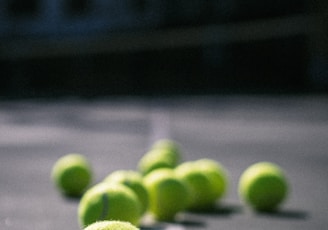 green tennis ball on gray concrete floor