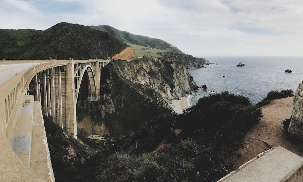 white bridge over the sea during daytime