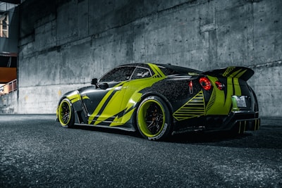 A sleek car wrapped in vibrant, eye-catching graphics cruising through the city.