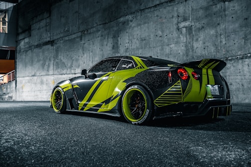 A sleek vehicle wrapped with vibrant Mandacaru Visual graphics in green and orange.