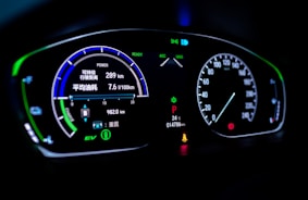 Digital diagnostic scanner connected to a car dashboard displaying data