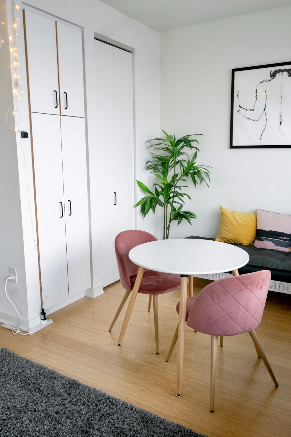 brown wooden round table beside white wooden cabinet