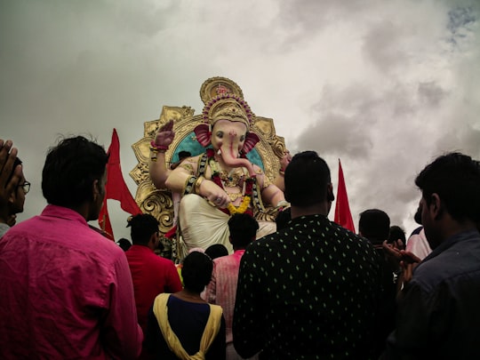 people in red and gold traditional dress in Girgaon India