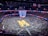A vibrant basketball viewing event with fans cheering in front of a large projector screen.