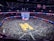 A vibrant basketball viewing event with fans cheering in front of a large projector screen.