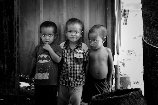 2 boys standing near wooden door