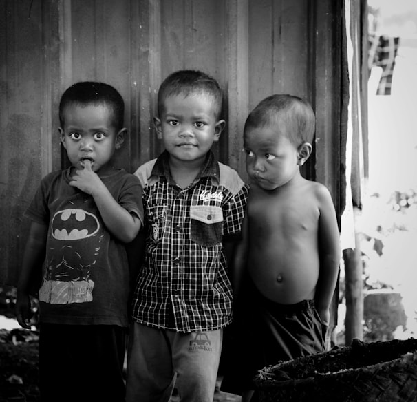 2 boys standing near wooden door