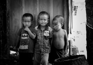 2 boys standing near wooden door