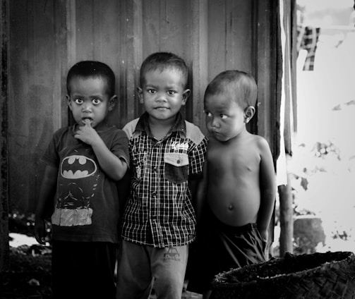 2 boys standing near wooden door