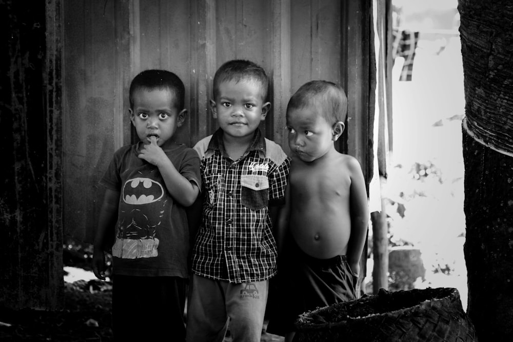 2 boys standing near wooden door