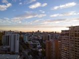 A panoramic view of a city skyline at sunset, highlighting urban living opportunities.