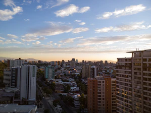 A panoramic view of Hyderabad skyline at sunset, highlighting modern apartments and villas.