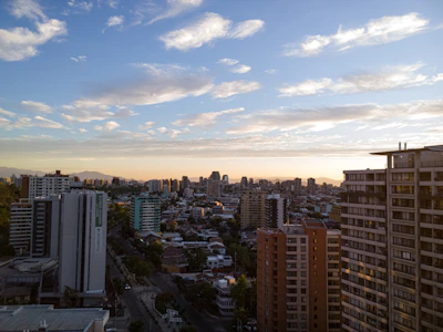A panoramic view of Hyderabad skyline at sunset, highlighting modern apartments and villas.