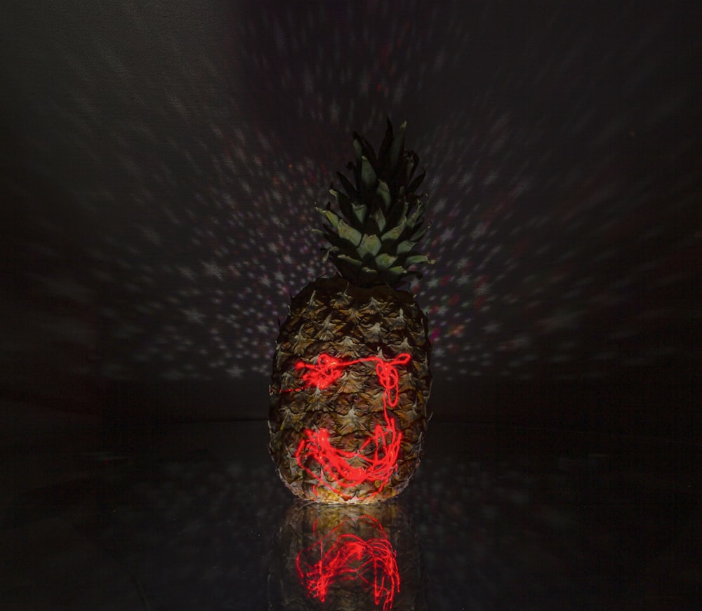 red and green pineapple figurine
