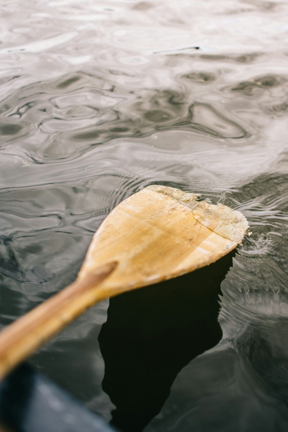 brown wooden paddle on water