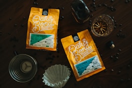 An assortment of Octopi Brewing coffee packs arranged on a rustic wooden table.