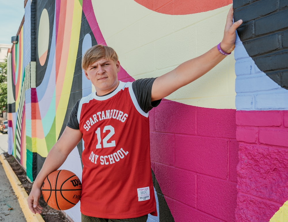 Boy in red and white crew neck t-shirt holding basketball photo – Free  Sports Image on Unsplash