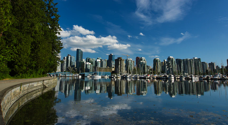 Stanley Park Seawall with Vancouver skyline reflecting in Coal Harbour