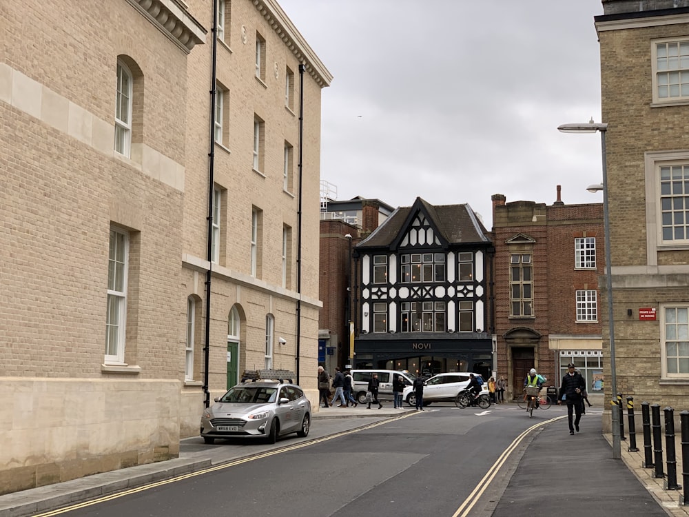 cars parked in front of brown building