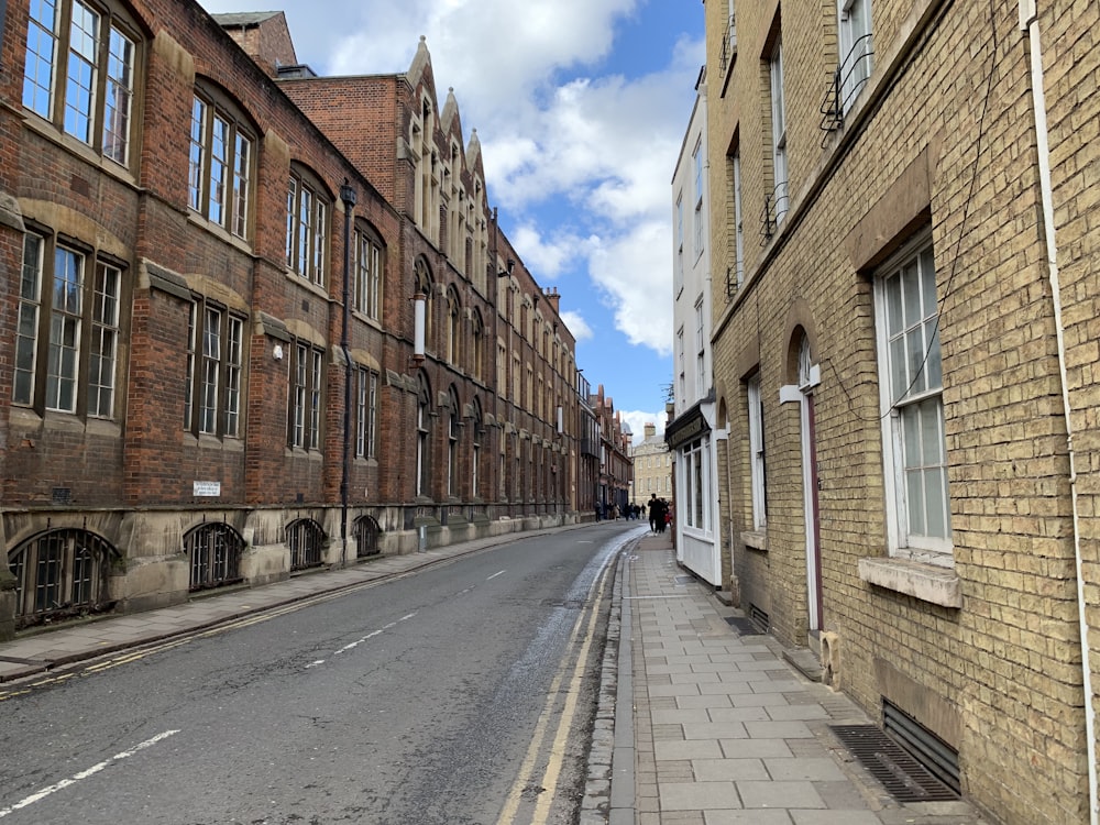 brown brick building beside road during daytime