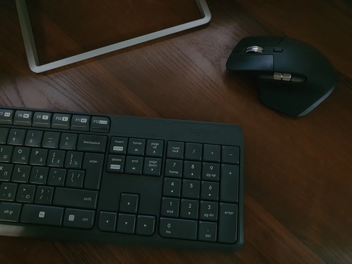 black computer keyboard beside white ipad