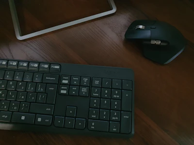 black computer keyboard beside white ipad