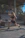 woman in black sports bra and black shorts sitting on concrete bench during daytime