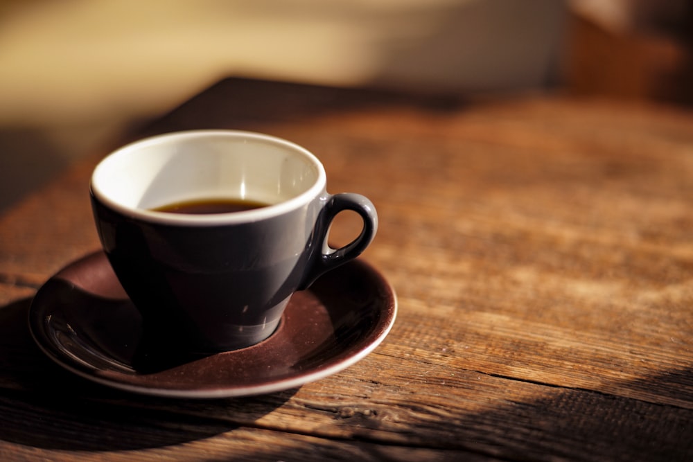 black ceramic mug on brown wooden table