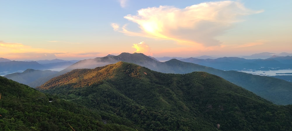 green mountain under white clouds during daytime