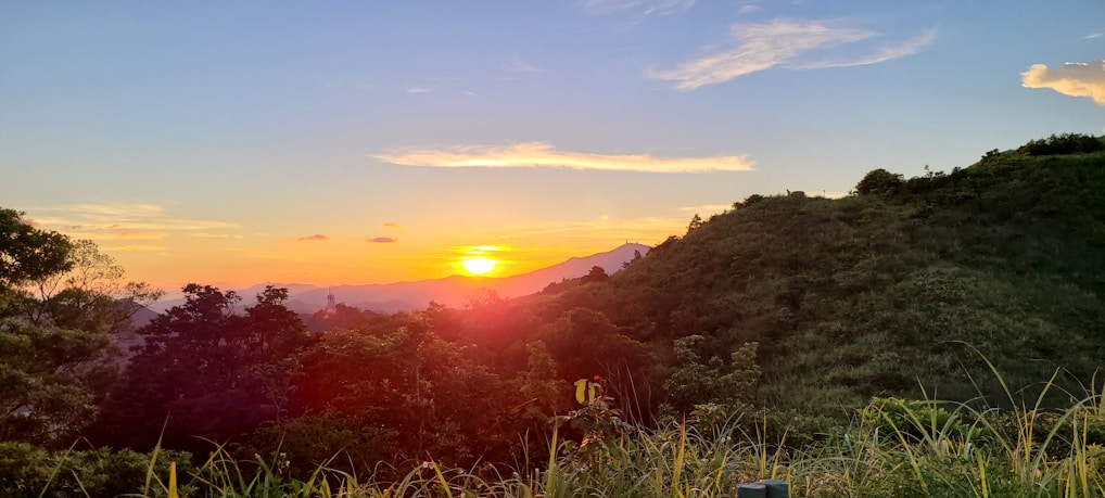 Sunset view over the Morro do Chapéu hills with vibrant orange and green hues.
