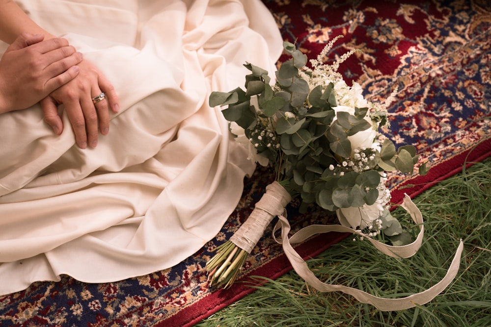 person holding white rose bouquet