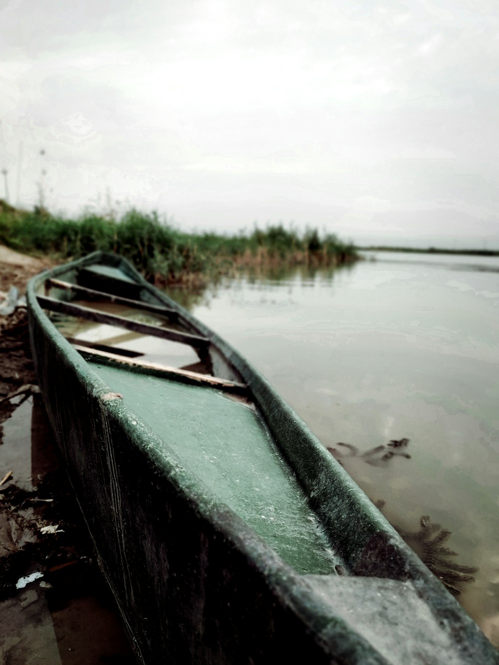 green and white canoe on lake during daytime