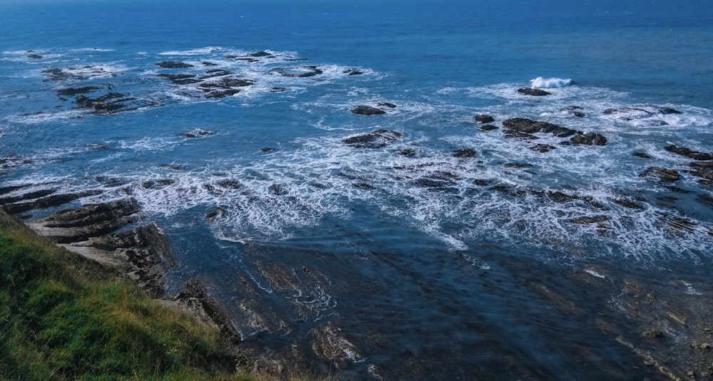 aerial view of ocean waves crashing on shore during daytime