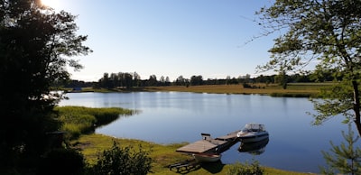 brown wooden boat on lake during daytime