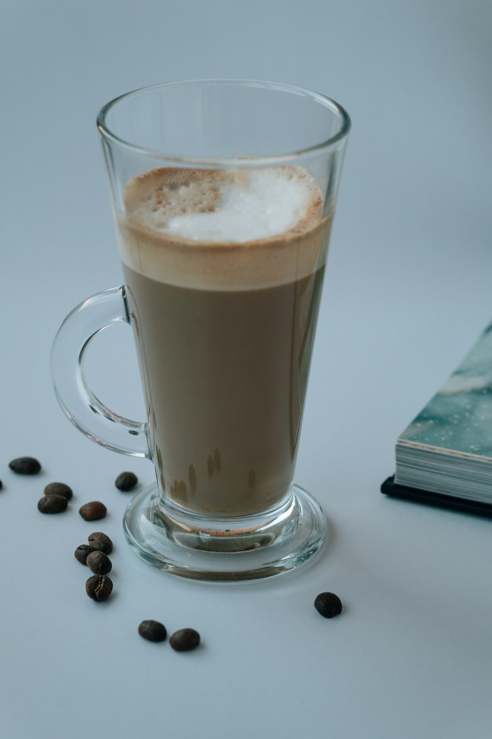 clear glass mug with brown liquid