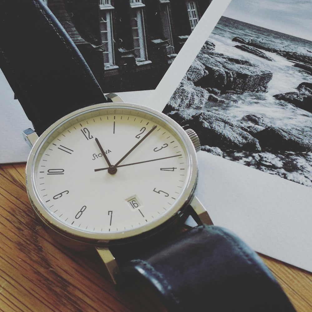 white and silver round analog wall clock