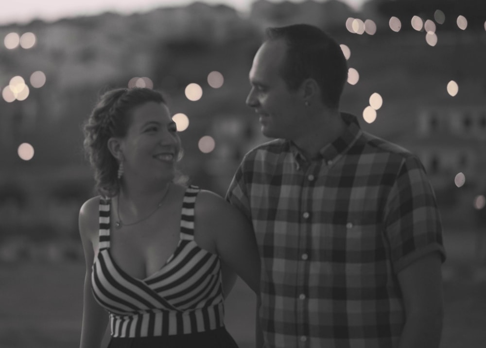 man and woman standing side by side during night time