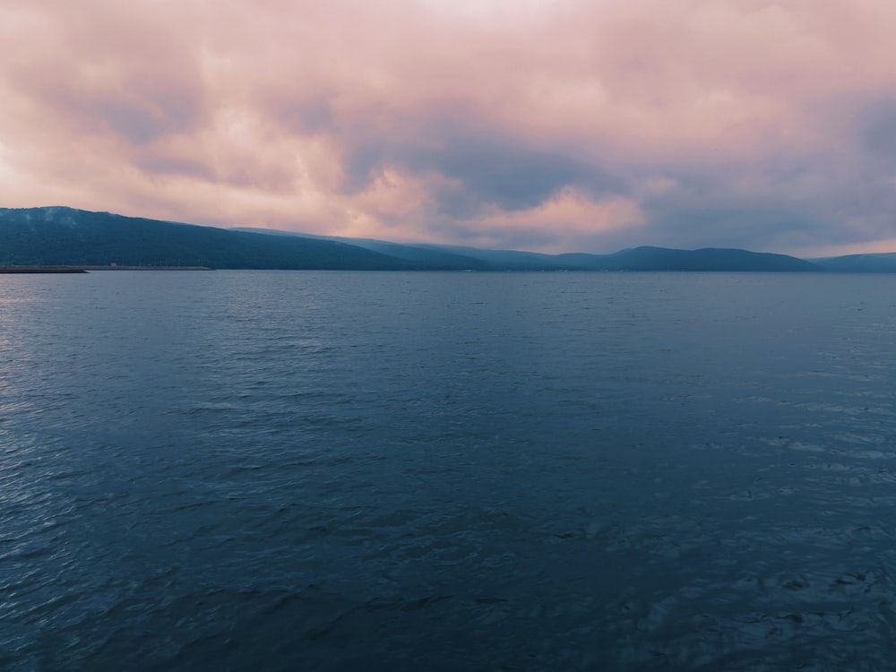 body of water under cloudy sky during daytime