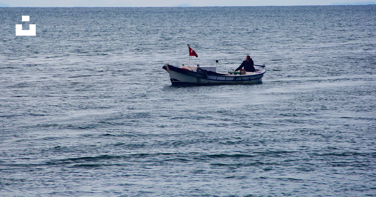 2 people riding on boat on sea during daytime photo – Free Grey Image ...