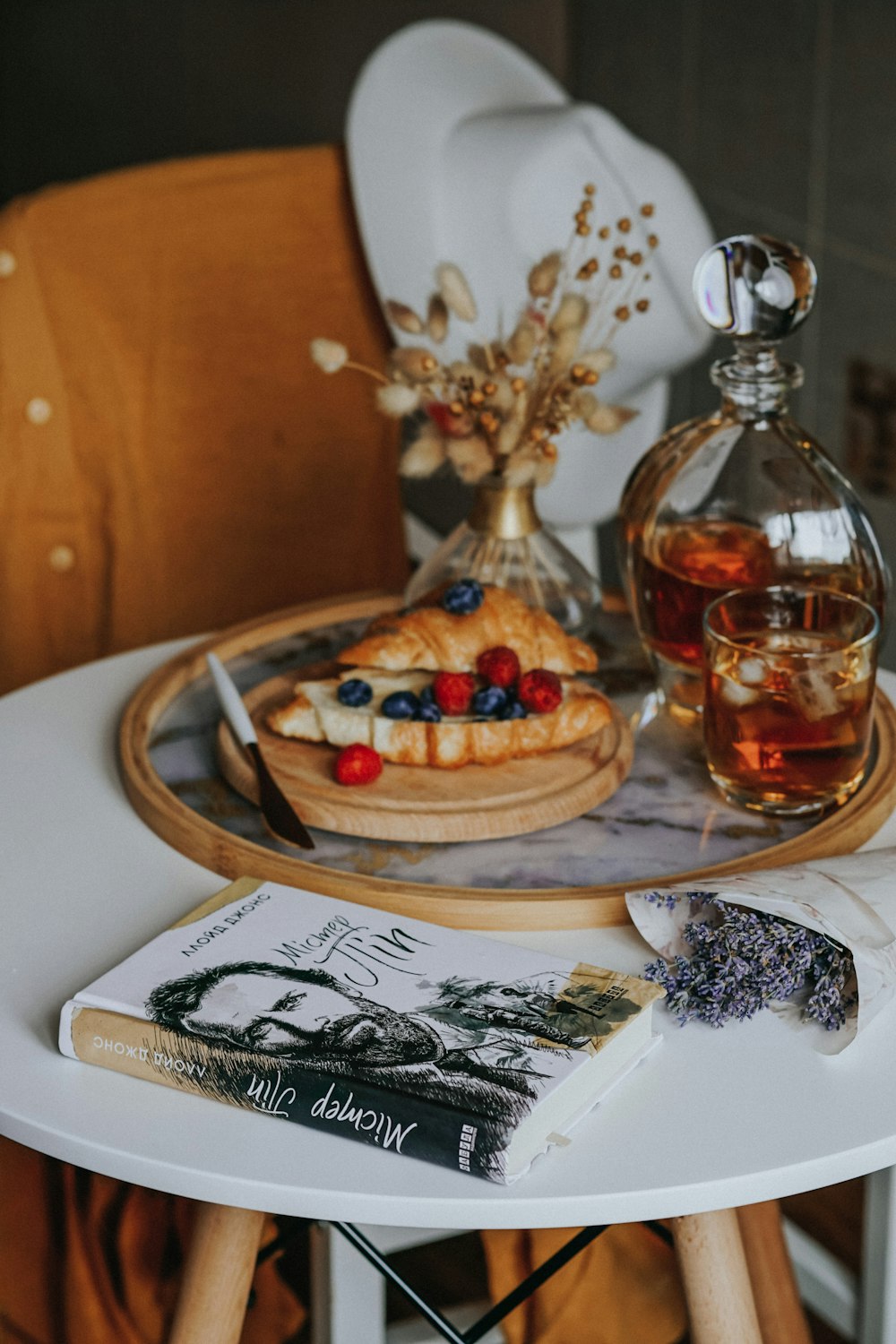 clear glass bottle on white ceramic plate